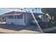 Well-maintained manufactured home with covered parking and desert landscaping at 44 S Hawes Rd # C13, Mesa, AZ 85208