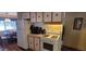 Functional kitchen with white appliances and a dining area nearby at 44 S Hawes Rd # C13, Mesa, AZ 85208