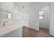 Bright bathroom featuring a stylish vanity, walk-in shower, and sleek tile flooring at 44729 N 44Th Dr, Phoenix, AZ 85087