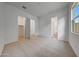 Bedroom with neutral carpet, a large window, and multiple doorways at 44729 N 44Th Dr, Phoenix, AZ 85087