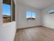 Bright, airy bedroom with wood-look tile floors and two large windows with neighborhood views at 44729 N 44Th Dr, Phoenix, AZ 85087