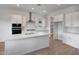 Modern kitchen with white cabinets, quartz countertops, and stainless steel appliances at 44729 N 44Th Dr, Phoenix, AZ 85087