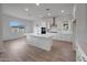 Open-concept kitchen featuring a large island, white cabinets, and ample counter space at 44729 N 44Th Dr, Phoenix, AZ 85087