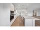 Bright kitchen with stainless steel appliances, white cabinets, and a large island at 44729 N 44Th Dr, Phoenix, AZ 85087