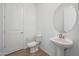 Bright powder room with pedestal sink and decorative mirror at 44729 N 44Th Dr, Phoenix, AZ 85087