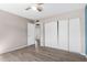 Bright bedroom featuring wood-look floors and a spacious closet with sliding doors at 4722 W Escuda Dr, Glendale, AZ 85308