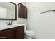 Bathroom features dark cabinets, a matching mirror, and a white sink at 501 W Hononegh Dr # 2, Phoenix, AZ 85027