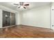 Bedroom boasts sleek laminate floors, a ceiling fan, and a sliding glass door at 501 W Hononegh Dr # 2, Phoenix, AZ 85027