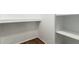 This closet features a wood floor and white-painted walls and shelving at 501 W Hononegh Dr # 2, Phoenix, AZ 85027