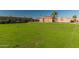 A community with a large grassy field, mature trees, and well-maintained buildings at 501 W Hononegh Dr # 2, Phoenix, AZ 85027
