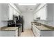 A well-lit kitchen featuring granite countertops, stainless steel appliances, and a tiled floor at 501 W Hononegh Dr # 2, Phoenix, AZ 85027