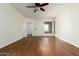 Bright living room with laminate floors, neutral walls, ceiling fan, and a view of the front entry at 501 W Hononegh Dr # 2, Phoenix, AZ 85027