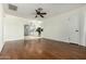 Open-concept living room with laminate floors, neutral walls, ceiling fan, and open access to kitchen at 501 W Hononegh Dr # 2, Phoenix, AZ 85027