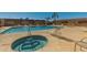 Community pool and hot tub with lounge chairs for relaxing by the pool at 501 W Hononegh Dr # 2, Phoenix, AZ 85027