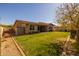 Well-maintained backyard with lush green grass, manicured landscaping, and a private fence at 5054 S Advant Ter, Mesa, AZ 85212