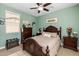 This bedroom features wooden furnishings, neutral-colored walls, and lots of natural light at 5054 S Advant Ter, Mesa, AZ 85212