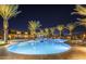 Community pool illuminated at night with poolside seating, palm trees, and ample space for recreation at 5054 S Advant Ter, Mesa, AZ 85212