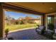 Relaxing covered patio with wicker seating overlooks the beautifully landscaped backyard at 5054 S Advant Ter, Mesa, AZ 85212