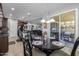 Casual dining area with seating near the open kitchen and outdoor access via sliding doors at 5054 S Advant Ter, Mesa, AZ 85212