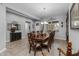 Formal dining room with a large wooden table and elegant chandelier at 5054 S Advant Ter, Mesa, AZ 85212