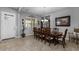 Well-lit dining room featuring a wooden table, chandelier, and tile flooring at 5054 S Advant Ter, Mesa, AZ 85212
