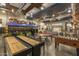 Spacious game room with shuffleboard, foosball, pool tables, and a fun bus-themed seating area at 5054 S Advant Ter, Mesa, AZ 85212