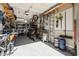Cluttered garage with storage shelves, ladders, bikes, and other equipment at 5054 S Advant Ter, Mesa, AZ 85212