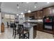 Kitchen with island seating, dark cabinets, and modern appliances under recessed lighting at 5054 S Advant Ter, Mesa, AZ 85212