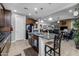 Modern kitchen island with bar seating, dark wood cabinets and stainless-steel appliances at 5054 S Advant Ter, Mesa, AZ 85212