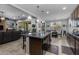 Spacious open kitchen featuring a large granite island and seamless flow to the living area at 5054 S Advant Ter, Mesa, AZ 85212
