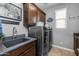 Well-organized laundry room with a sink, front-loading washer and dryer, and plenty of cabinet space at 5054 S Advant Ter, Mesa, AZ 85212