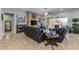 Comfortable living room with a brick fireplace, ceiling fan, and neutral colors at 5054 S Advant Ter, Mesa, AZ 85212