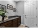 The mud room features a granite countertop, a utility sink, and a door to the outside at 5054 S Advant Ter, Mesa, AZ 85212