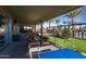 Inviting covered outdoor lounge with cozy seating, a ping pong table, and lush landscaping at 5054 S Advant Ter, Mesa, AZ 85212