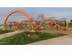Community playground with unique climbing structure, slides, and open green spaces at 5054 S Advant Ter, Mesa, AZ 85212