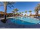 Stunning community pool area surrounded by lush palm trees and comfortable lounge chairs at 5054 S Advant Ter, Mesa, AZ 85212