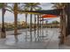 Community splash pad with water feature, palm trees, and shade coverings on a cloudy day at 5054 S Advant Ter, Mesa, AZ 85212