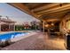 Expansive backyard showcasing a pool, covered seating areas, outdoor kitchen, and well-maintained landscaping at 5641 E Aster Dr, Scottsdale, AZ 85254