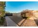 View of a gated area in the backyard, featuring a block wall and paved walkway at 5641 E Aster Dr, Scottsdale, AZ 85254