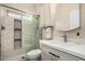 Updated bathroom with a glass shower door, hexagon tile floors, and a white vanity at 5641 E Aster Dr, Scottsdale, AZ 85254