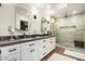 Bright bathroom featuring double sinks, quartz countertop and glass enclosed shower at 5641 E Aster Dr, Scottsdale, AZ 85254