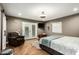 Primary bedroom featuring outdoor access, a barn door and tv at 5641 E Aster Dr, Scottsdale, AZ 85254