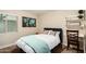 Comfortable bedroom with a queen bed, world art, and a charming ladder shelf at 5641 E Aster Dr, Scottsdale, AZ 85254
