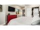 Bright bedroom with a red dresser, TV, and sliding closet doors at 5641 E Aster Dr, Scottsdale, AZ 85254