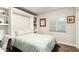 Cozy bedroom featuring a stylish green and white patterned bedspread and a built-in desk and shelving at 5641 E Aster Dr, Scottsdale, AZ 85254