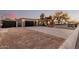 Gorgeous home with modern garage, desert landscaping, and inviting entryway with warm lighting at 5641 E Aster Dr, Scottsdale, AZ 85254