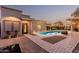 Inviting front exterior with a well-lit path, leading to a charming home and a beautifully landscaped yard at 5641 E Aster Dr, Scottsdale, AZ 85254