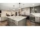 Open kitchen with stainless steel appliances, granite island, and a view to the living area at 5641 E Aster Dr, Scottsdale, AZ 85254