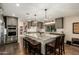Modern kitchen features a large island, pendant lighting, stainless appliances, and barstool seating at 5641 E Aster Dr, Scottsdale, AZ 85254