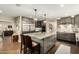 Modern kitchen featuring a large island, stainless steel appliances, and pendant lighting at 5641 E Aster Dr, Scottsdale, AZ 85254